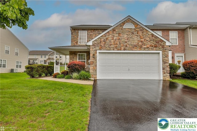 view of front of house with stone siding, driveway, a front lawn, cooling unit, and a garage