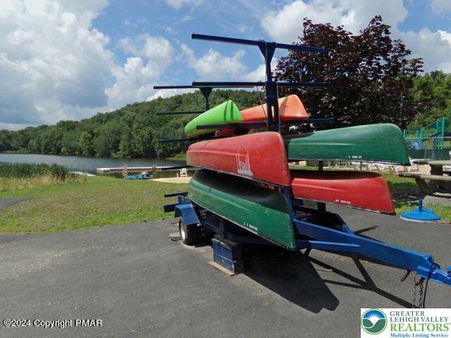 2171 Lancaster Dr, Lehman Twp, PA 18324 - view of playground with a water view, a lawn, and a wooded view