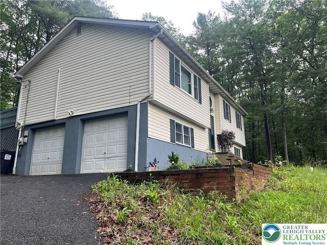2637 Fernwood Ave, Jackson Twp, PA 18321 - view of home's exterior with a garage, asphalt driveway, and stucco siding