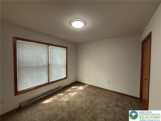 unfurnished room featuring a baseboard heating unit, carpet floors, and baseboards