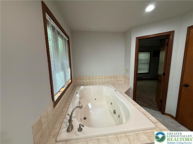 full bathroom with a tub with jets