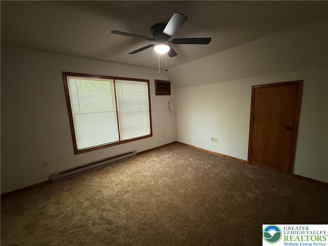 spare room with a baseboard heating unit, lofted ceiling, ceiling fan, carpet flooring, and baseboards
