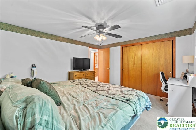 carpeted bedroom with a closet and a ceiling fan