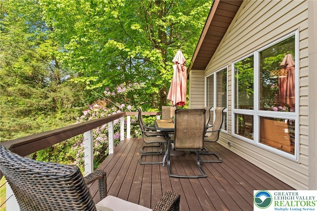 deck featuring outdoor dining area