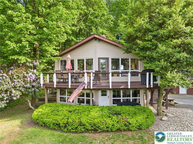 back of house featuring a wooden deck and stairway