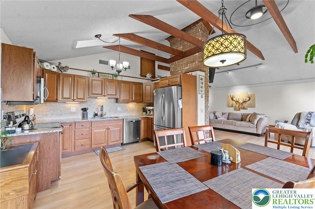 dining room featuring light wood-type flooring, a chandelier, beamed ceiling, high vaulted ceiling, and a textured ceiling