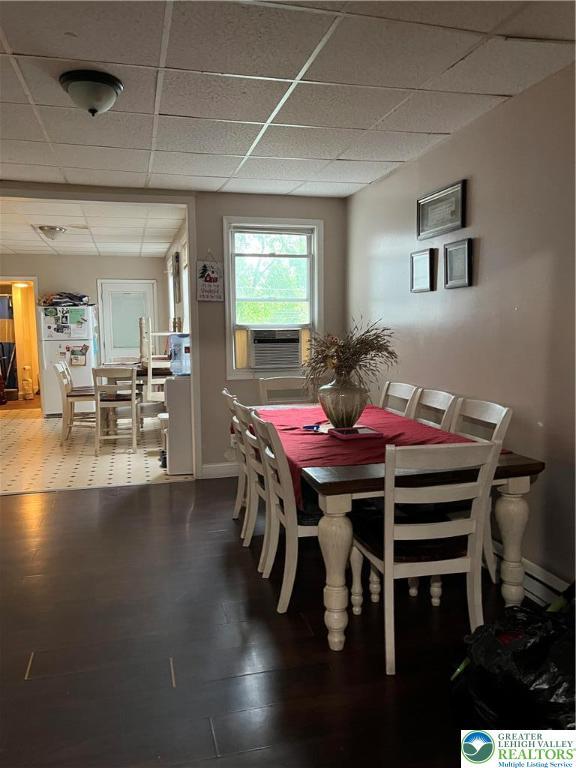 310 E Broad St, Tamaqua Borough, PA 18252 - dining area featuring a drop ceiling, cooling unit, wood finished floors, and baseboards