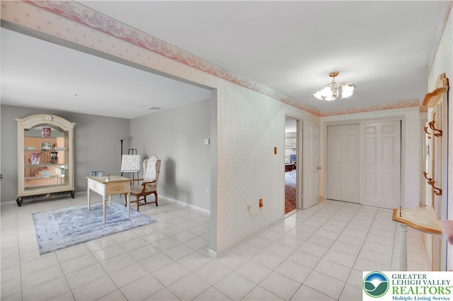 entrance foyer featuring wallpapered walls, a chandelier, baseboards, and light tile patterned floors