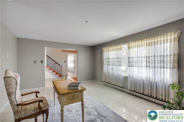 living room featuring baseboard heating, stairway, tile patterned flooring, and baseboards