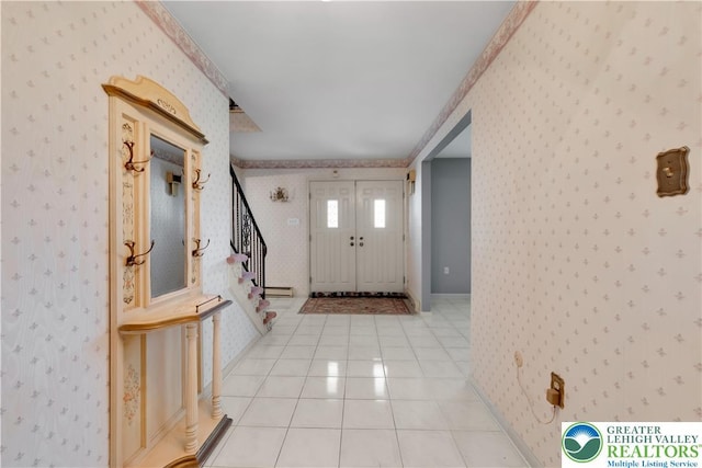 foyer featuring wallpapered walls, baseboards, stairs, and light tile patterned floors