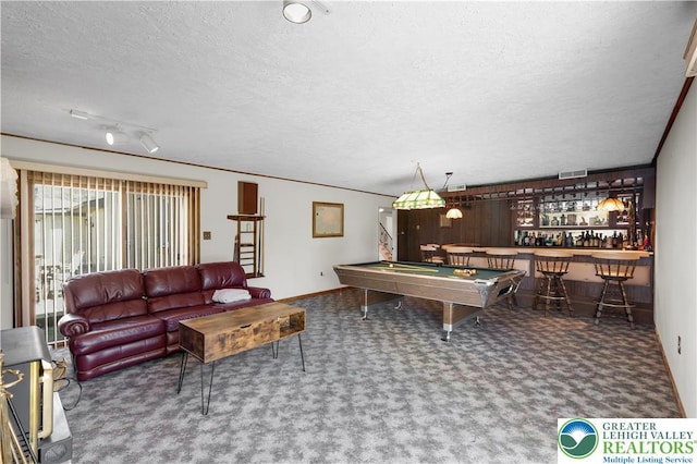 recreation room with a textured ceiling, carpet flooring, billiards, a bar, and baseboards