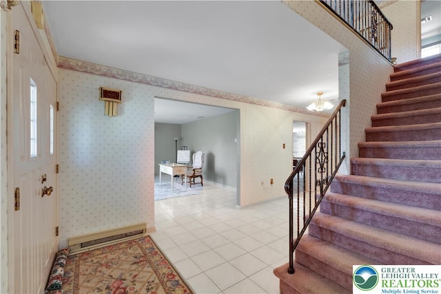 entrance foyer featuring wallpapered walls, stairway, light tile patterned floors, a chandelier, and baseboards
