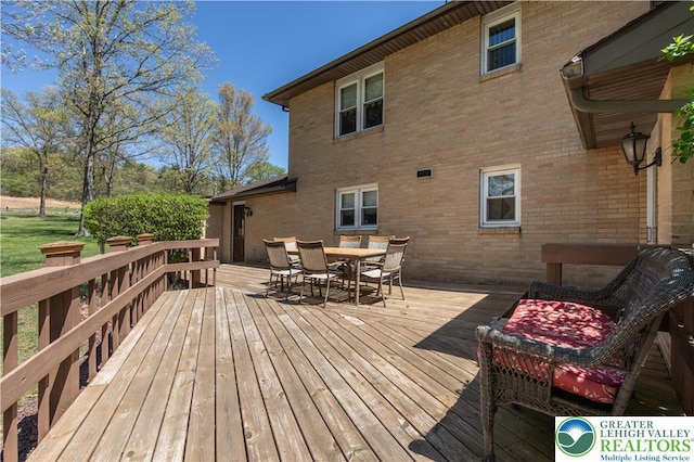 wooden terrace featuring outdoor dining area