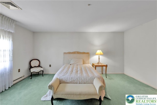 bedroom featuring light carpet and a baseboard heating unit