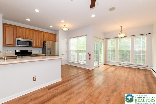 5221 Chandler Way S, Whitehall Twp, PA 18069 - kitchen with stainless steel appliances, light countertops, light wood finished floors, brown cabinets, and recessed lighting