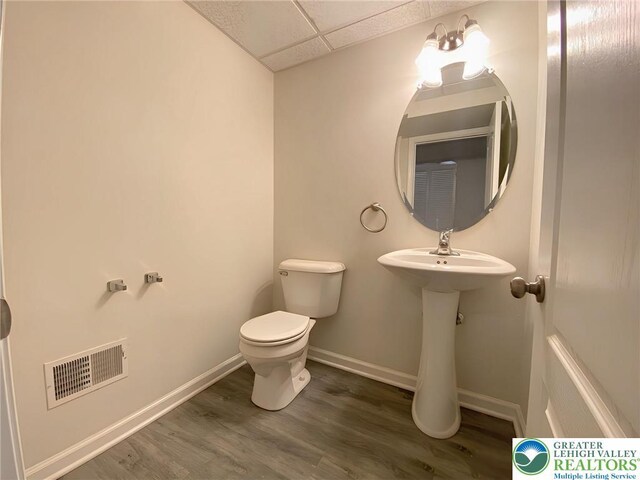 306 Redclover Ln, Upper Macungie Twp, PA 18104 - half bath featuring toilet, a drop ceiling, wood finished floors, and baseboards