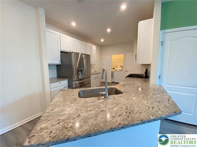 306 Redclover Ln, Upper Macungie Twp, PA 18104 - kitchen with a sink, stainless steel refrigerator with ice dispenser, separate washer and dryer, white cabinetry, and recessed lighting