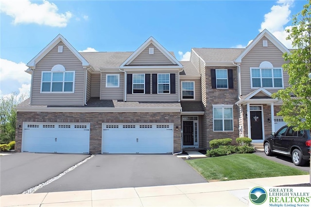 306 Redclover Ln, Upper Macungie Twp, PA 18104 - view of property with driveway, stone siding, a garage, and a front lawn