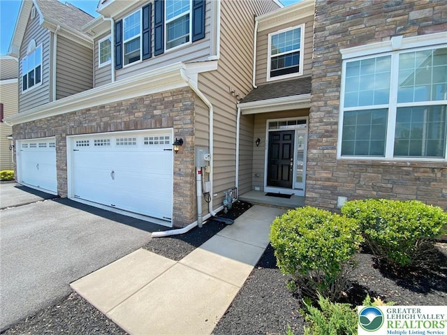 306 Redclover Ln, Upper Macungie Twp, PA 18104 - entrance to property with stone siding, an attached garage, and driveway