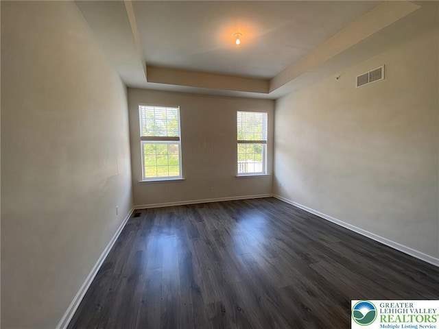 306 Redclover Ln, Upper Macungie Twp, PA 18104 - empty room with baseboards, dark wood-type flooring, and a tray ceiling