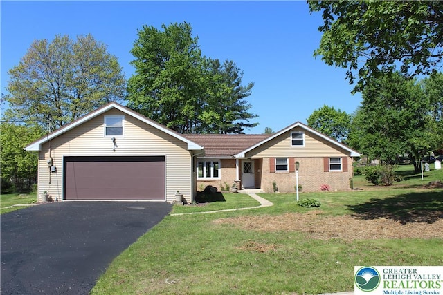 ranch-style home featuring driveway, an attached garage, a front yard, and brick siding
