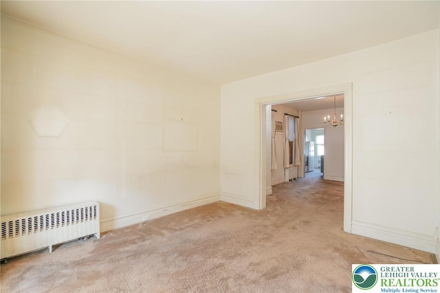 415 Hazle St, Tamaqua Borough, PA 18252 - empty room with radiator, carpet floors, a chandelier, and baseboards