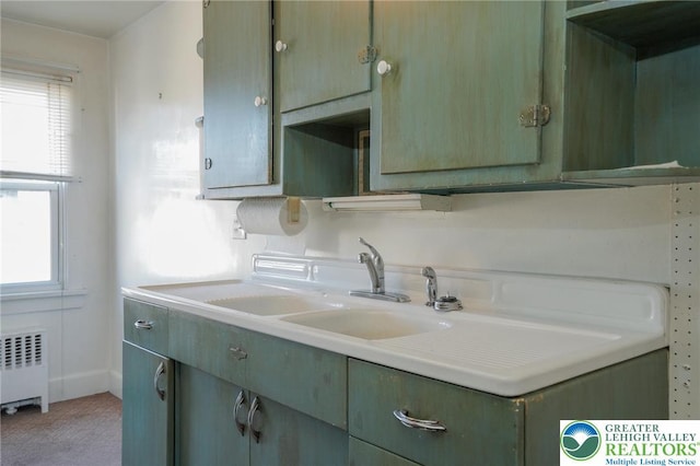 415 Hazle St, Tamaqua Borough, PA 18252 - kitchen featuring radiator heating unit, light countertops, and light colored carpet