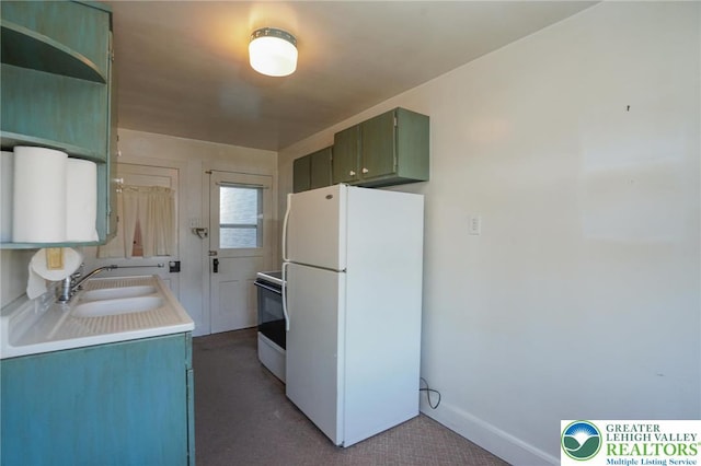 415 Hazle St, Tamaqua Borough, PA 18252 - kitchen featuring freestanding refrigerator, range with electric cooktop, a sink, light countertops, and carpet floors