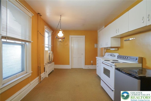 415 Hazle St, Tamaqua Borough, PA 18252 - kitchen featuring electric range, white cabinets, light carpet, pendant lighting, and baseboards