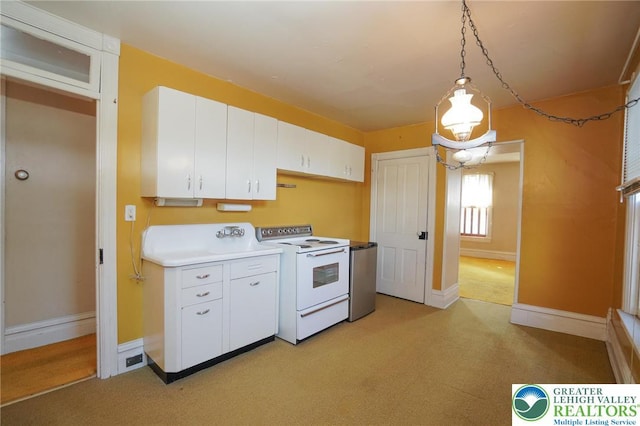 415 Hazle St, Tamaqua Borough, PA 18252 - kitchen featuring electric range, white cabinets, light countertops, baseboards, and hanging light fixtures