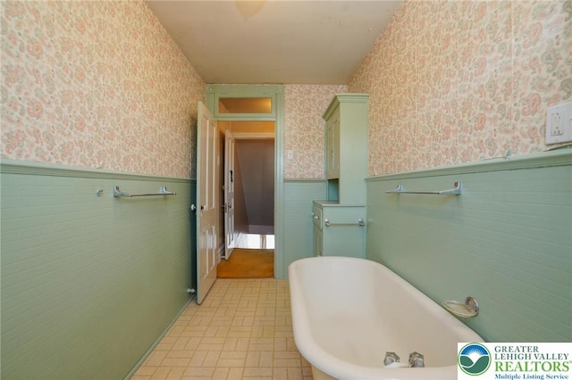 415 Hazle St, Tamaqua Borough, PA 18252 - bathroom with wallpapered walls, a wainscoted wall, and a freestanding bath