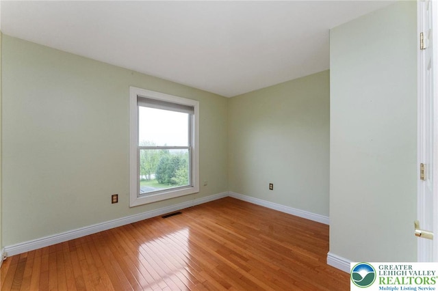unfurnished room featuring light wood-type flooring and baseboards