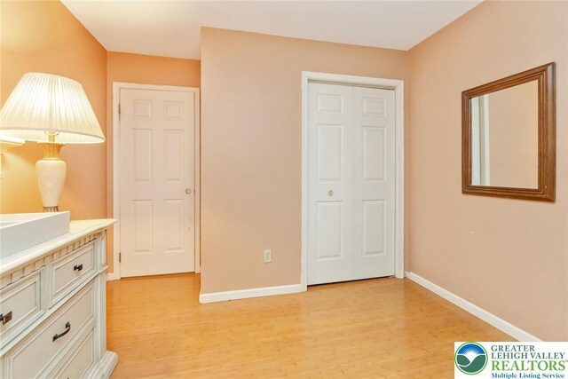 bedroom featuring light wood-type flooring and baseboards