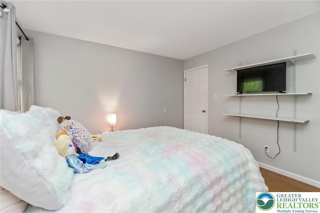 carpeted bedroom featuring baseboards