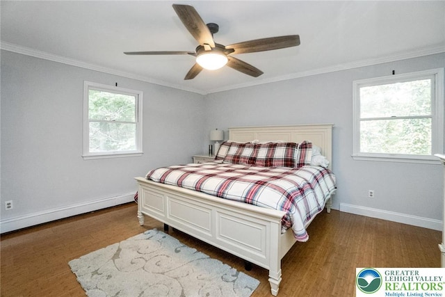 bedroom featuring wood finished floors, baseboards, crown molding, and ceiling fan