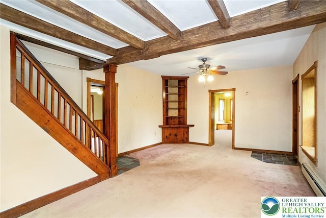 unfurnished living room with baseboard heating, carpet floors, beamed ceiling, stairway, and a skylight