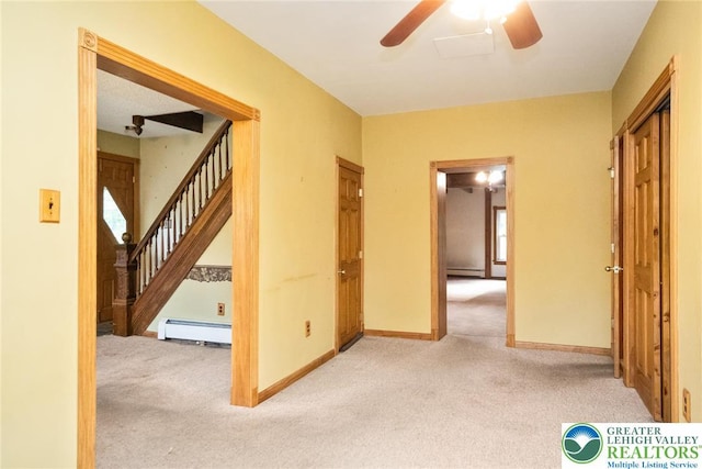 corridor featuring baseboard heating, carpet, stairs, and baseboards