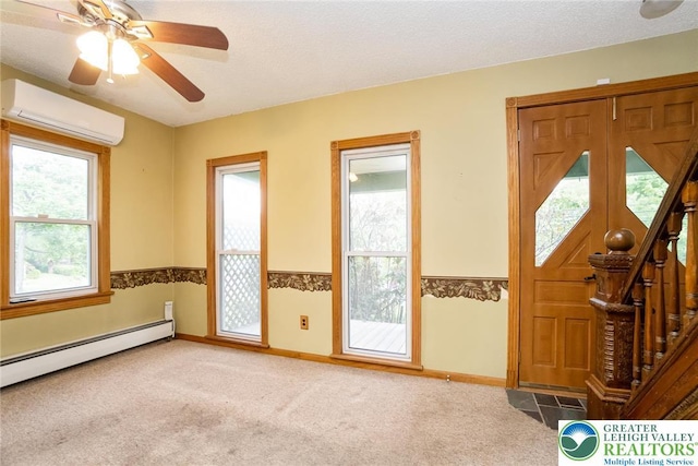 entryway with a wall mounted air conditioner, baseboard heating, carpet floors, baseboards, and a ceiling fan
