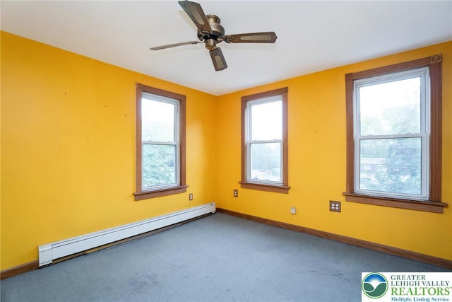 spare room with a baseboard radiator, carpet, baseboards, and ceiling fan