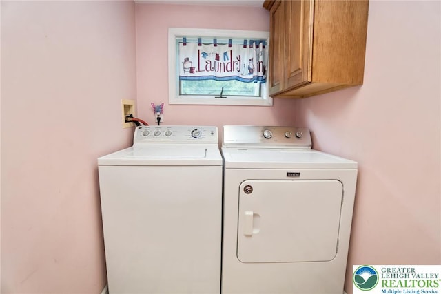 laundry area featuring cabinet space and separate washer and dryer