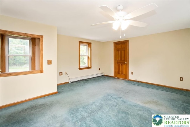 carpeted spare room featuring a baseboard radiator, plenty of natural light, baseboards, and a ceiling fan