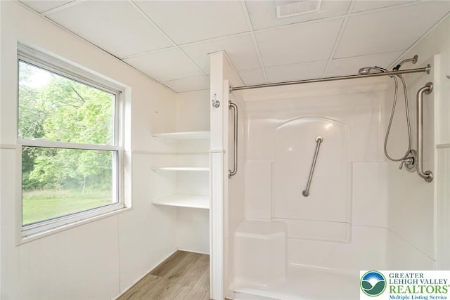 full bath featuring a shower and wood finished floors