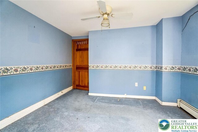 spare room with carpet, a baseboard radiator, ceiling fan, and baseboards