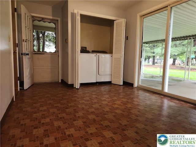 laundry area featuring washing machine and clothes dryer and baseboards