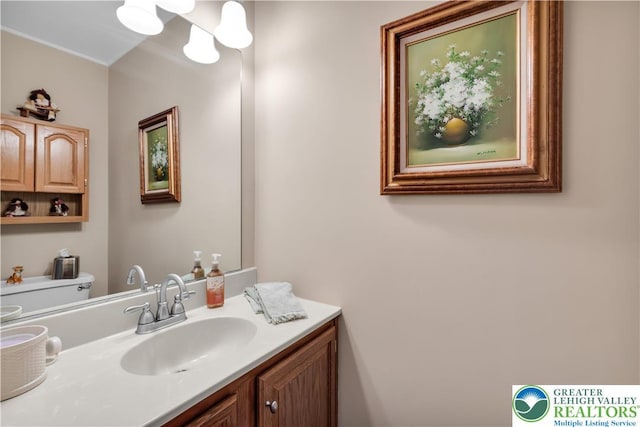 bathroom featuring toilet and vanity