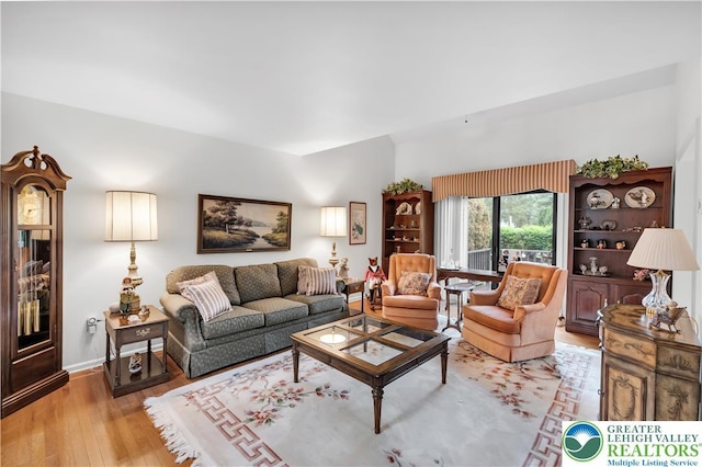 living area with wood finished floors and baseboards