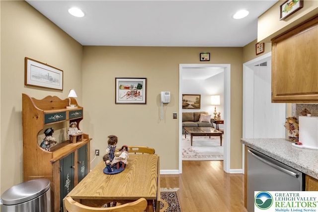 dining space with light wood finished floors, recessed lighting, and baseboards