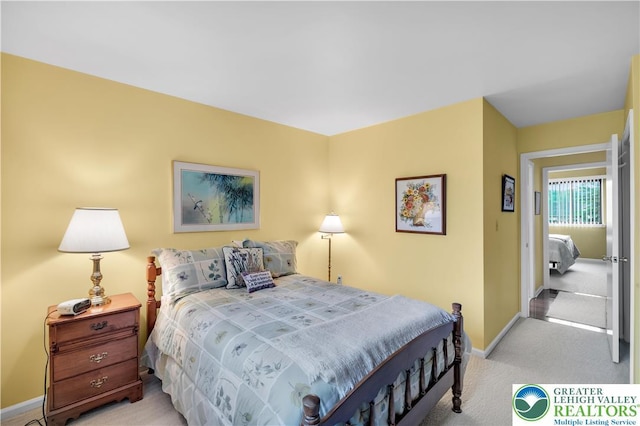 carpeted bedroom with baseboards