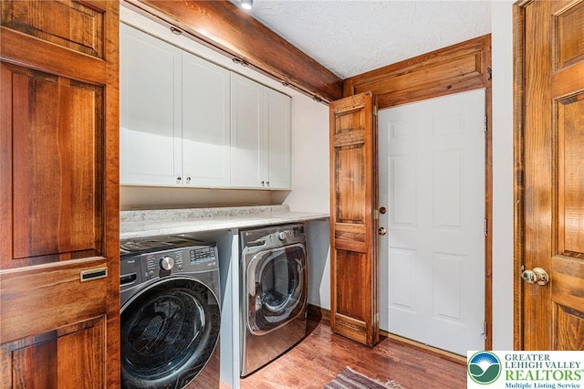 2342 Bobby Ct, South Whitehall Twp, PA 18069 - laundry area with cabinet space, washing machine and clothes dryer, wood finished floors, and a textured ceiling