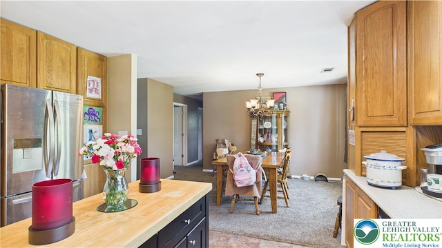 4168 Orefield Rd, South Whitehall Twp, PA 18104 - kitchen featuring stainless steel fridge with ice dispenser, a chandelier, light carpet, pendant lighting, and wood counters